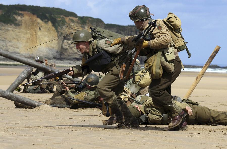 Des passionnés d'histoire portant des uniformes militaires américains de la Seconde Guerre mondiale, pour commémorer le Débarquement du 6 juin 1944 sur la plage normande de Omaha Beach à Vierville-sur-Mer, le 5 Juin 2014. [Photo/Agences]
