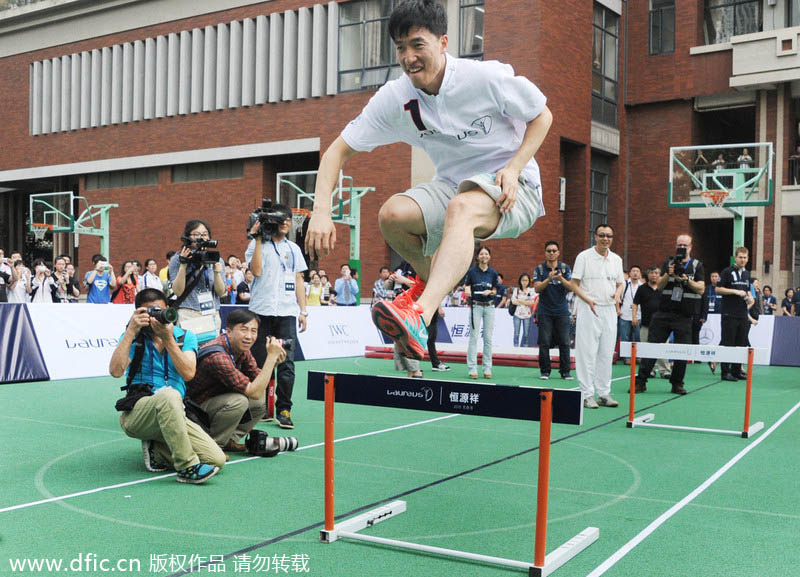 Le coureur chinois du 110m haies, Liu Xiang, en pleine action, lors d’une activité d’enseignement dans un lycée de Shanghai, le 9 juin 2014. [Photo/IC]