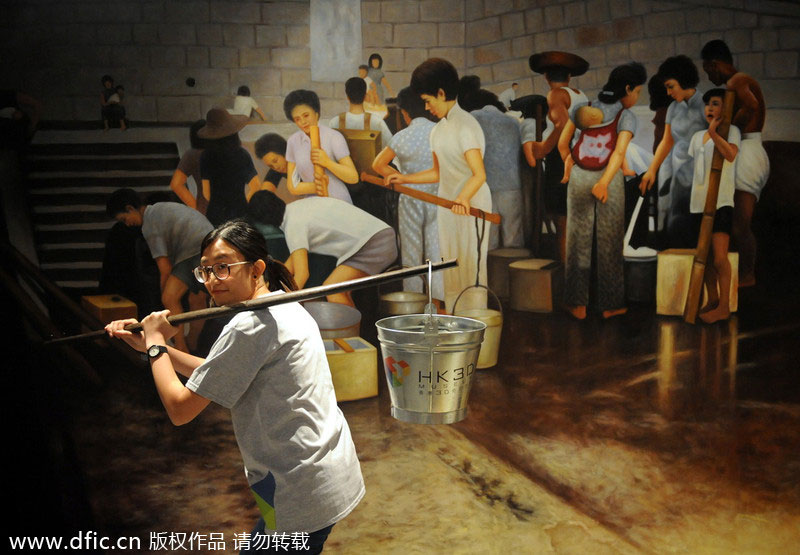 Une femme pose pour la photo devant une peinture 3D au musée 3D de Hong Kong, le 26 juin 2014.