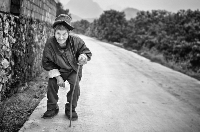 Une personne âgée tout sourire devant l’objectif de la photographe.