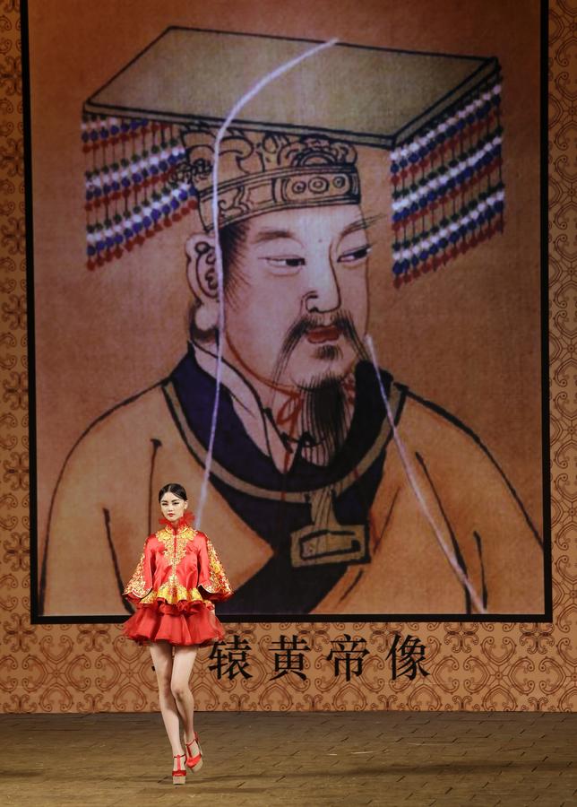 Un modèle, lors de la Collection de haute couture NE TIGER 2014, une création du designer chinois Zhang Zhifeng, devant une image de l’Empereur Jaune Xuan Yuan, considéré par beaucoup comme l'ancêtre du peuple chinois, à l’occasion de la China Fashion Week à Beijing, le 25 octobre 2014.