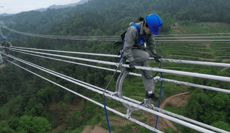 Hubei : une électricienne de 23 ans travaille en marchant sur une ligne UHV à 80 mètres du sol !