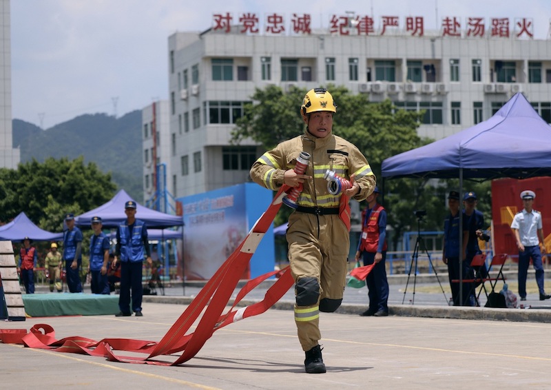 Un concurrent assiste à la première journée de la troisième édition du Concours de lutte contre l'incendie et de sauvetage Flamme Bleue dans le district de Huadu, à Guangzhou, capitale de la province du Guangdong, le 13 juillet 2023. (Zheng Erqi / chinadaily.com.cn)