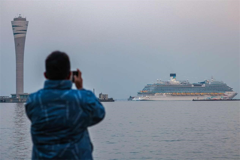 La photo montre un homme prenant des photos du navire. (Wang Chu / Pic.people.com.cn)
