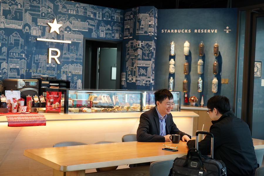 Des clients discutent dans un magasin Starbucks présentant des éléments du patrimoine culturel local, à Beijing, capitale de la Chine, le 27 novembre 2023. (Photo : Ren Chao)