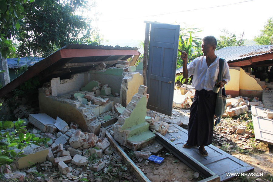 Un homme devant une maison effondrée à Tabaitgine, épicentre d'un séisme qui a touché la région de Mandalay, au Myanmar, le 11 novembre 2012. 