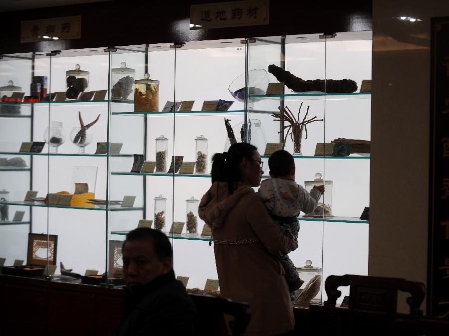 Une mère et sa fille regardent des herbes médicinales exposées dans la Faculté de Médecine Traditionnelle Chinoise du Shanxi à Taiyuan, capitale de la Province du Shanxi, dans le Nord de la Chine, le 23 novembre 2012..