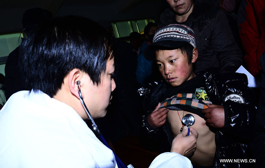 Luosong Zhaxi, un enfant âgé de dix ans souffrant d'une maladie cardiaque congénitale, se fait examiner par un médecin de l'Hôpital cardiovasculaire de la Croix rouge de l'Anhui, dans le district de Nangqian de la province du Qinghai (nord-ouest), le 3 décembre 2012. 