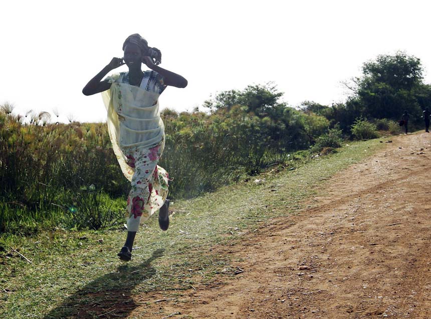 Le 23 avril 2012 à Rubkona au Soudan du Sud, une femme sud-soudanaise court sur une route durant un raid aérien. REUTERS / Goran Tomasevic