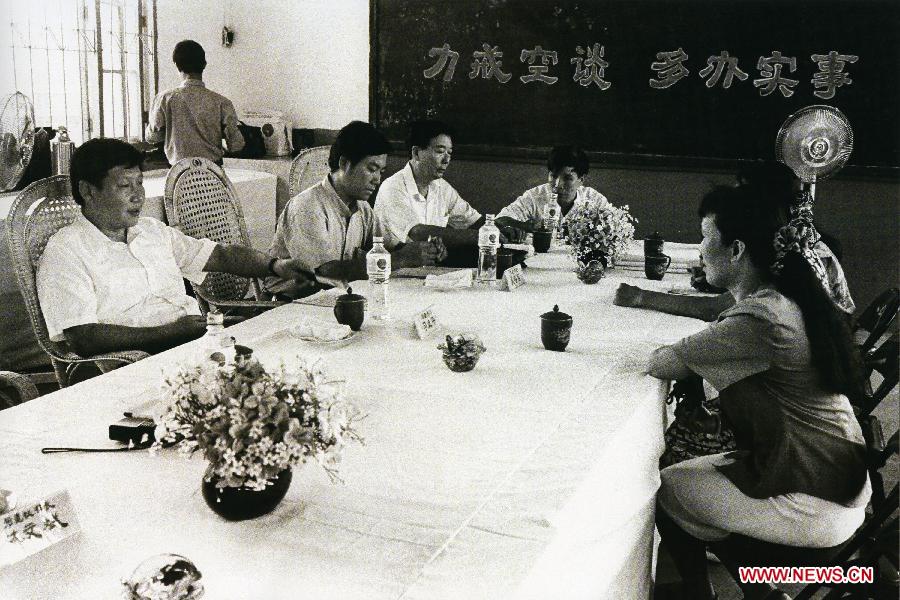 Photo d'archive prise en août 1993 montrant Xi Jinping (1er à gauche), alors qu'il était secrétaire du Comité du Parti communiste chinois (PCC) pour la municipalité de Fuzhou, rencontrant des citoyens à Fuzhou, capitale de la province du Fujian, dans le sud-est de la Chine.