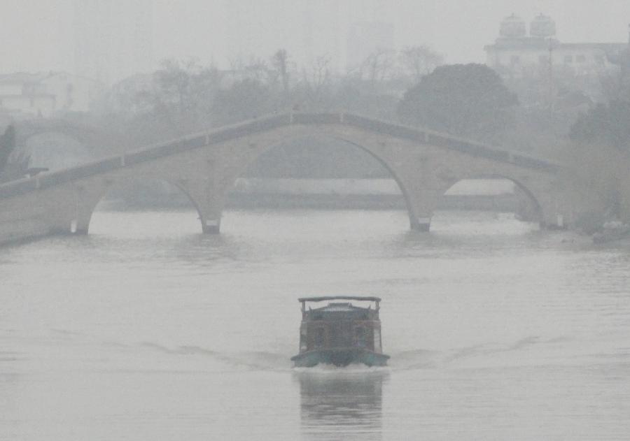 Un bateau navigue sur une rivière enveloppée de brouillard dans la ville de Suzhou, dans la province du Jiangsu, dans l'Est de la Chine, le 22 janvier 2013. (Xinhua / Wang Jiankang)