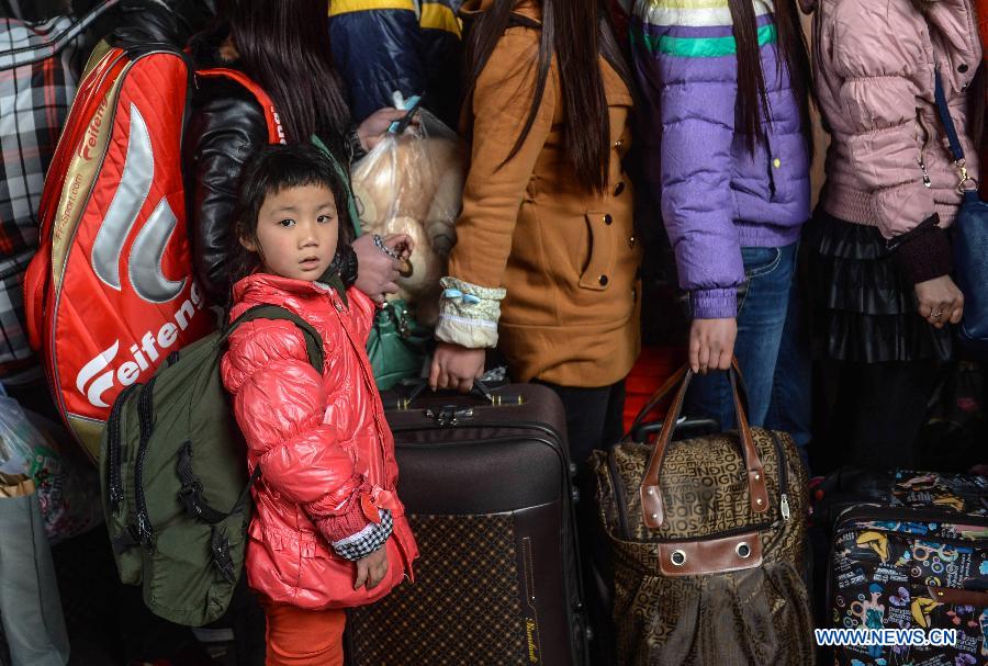 Le 27 janvier 2013 sur un quai de la gare de Hangzhou, une petite fille attend, avec sa mère, le train partant pour Guiyang. (Xinhua/Han Chuanhao)