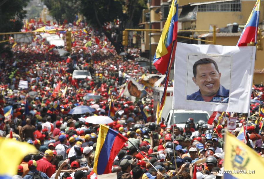 Des membres de la Garde nationale vénézuélienne forment une barrière de sécurité pour contenir la foule des deux côtés du cortège funéraire de leur défunt président Hugo Chvez. 