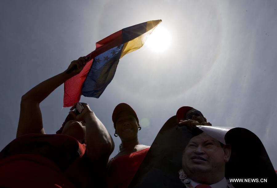 Le 6 mars 2013 dans les rues de Caracas, capitale vénézuélienne, des habitants accompagnent le cortège funéraire de leur défunt président Hugo Chavez. (Xinhua/AVN)