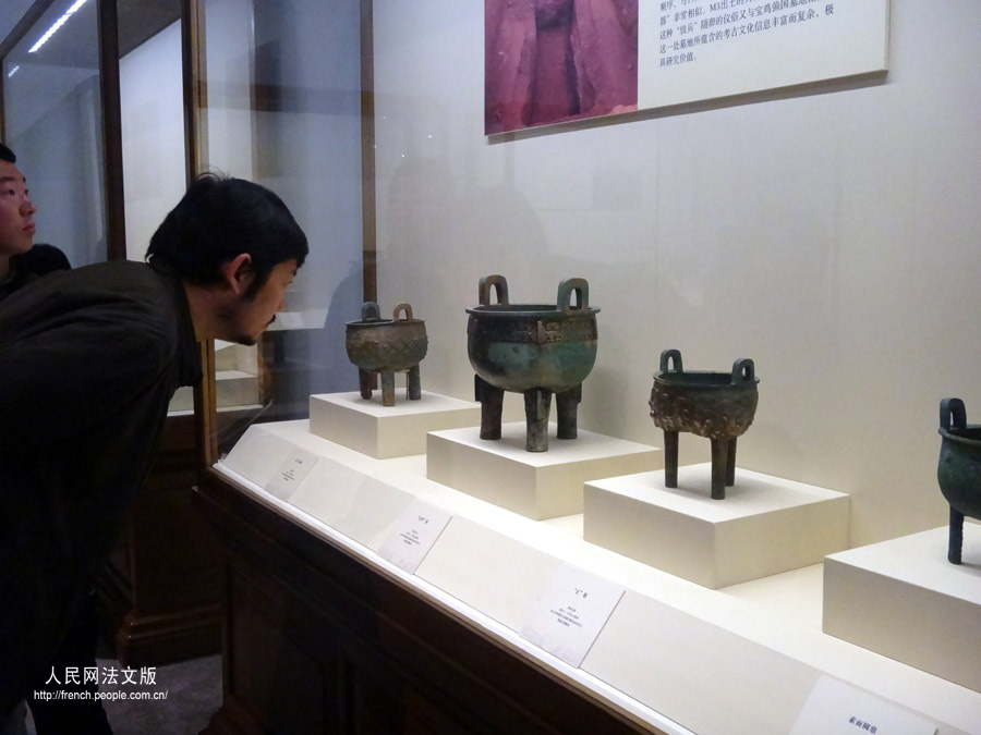 Un visiteur contemple des objets présents dans l'exposition "Regard sur le pays natal", au Musée national de Chine, à Beijing, le 17 mars 2013.