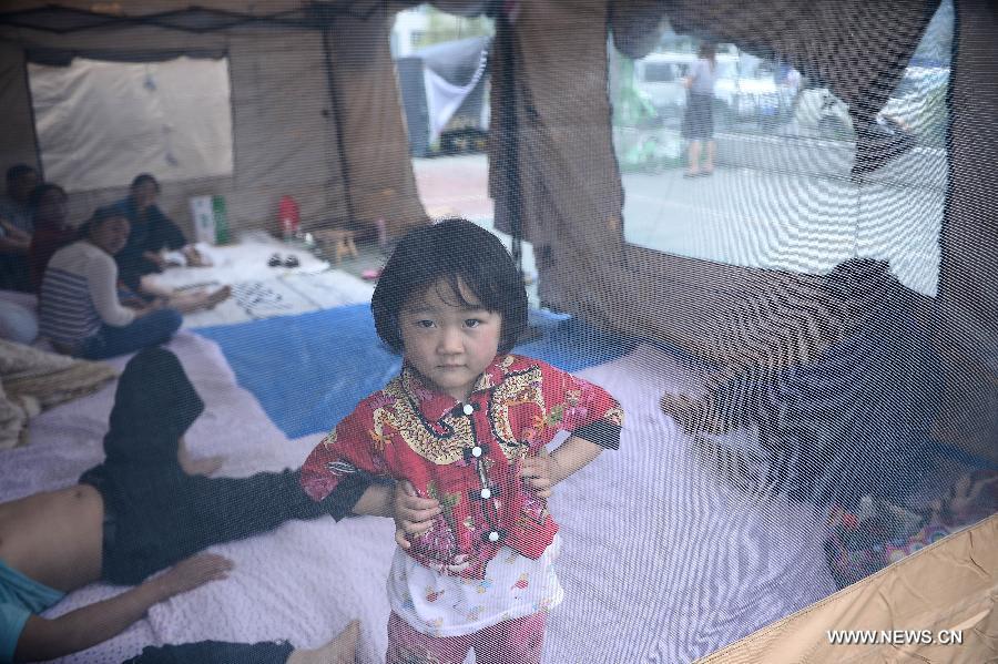 Yang Huiying, une petite fille âgée de 4 ans à l'intérieur d'une tente d'un camp d'abris temporaire de sinistrés à Lushan, un comté de la province du Sichuan frappé par un séisme de magnitude 7, samedi 20 avril 2013. (Photo : Xinhua/Zhang Hongxiang)