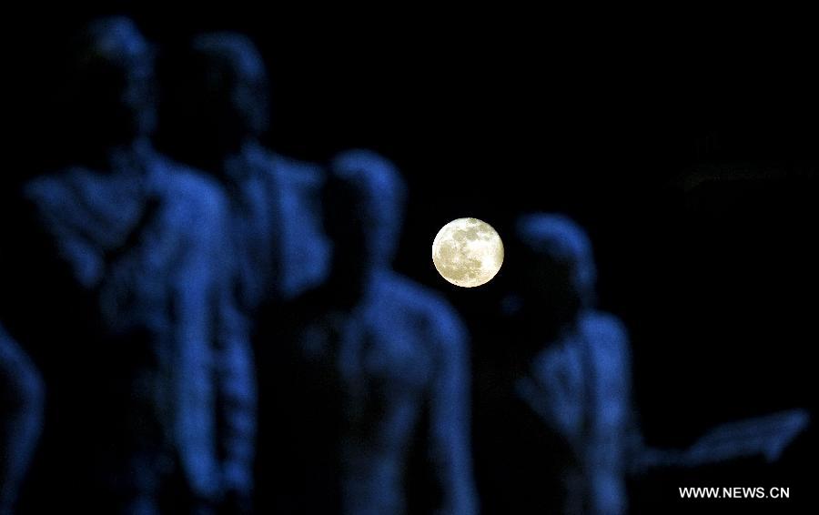 Le 26 avril, la pleine lune se lève des statues, à Skopje, la capitale macédonienne. (Photo: Xinhua/AFP)