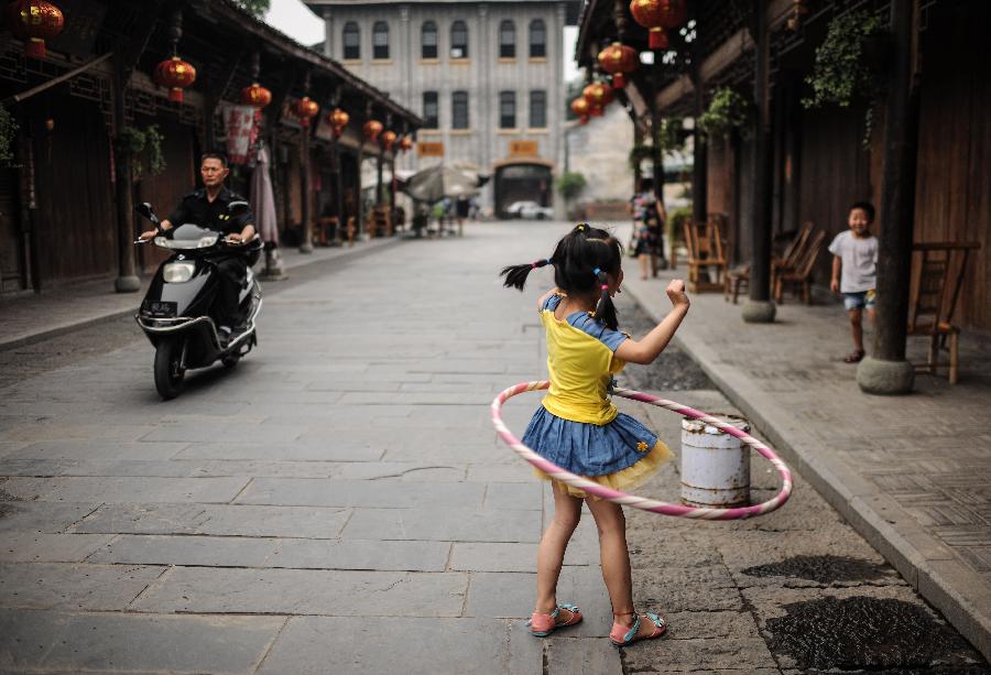 Une fillette joue à Anren, une ville ancienne du Comté de Dayi, à Chengdu, capitale de la Province du Sichuan, dans le Sud-ouest de la Chine, le 23 mai 2013.