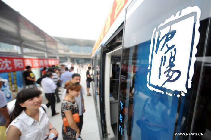 Des passagers se préparent à monter dans un tram, dans le nouveau district de Hunnan à Shenyang, (la capitale chinoise du Liaoning, au nord du pays), le 15 août 2013.