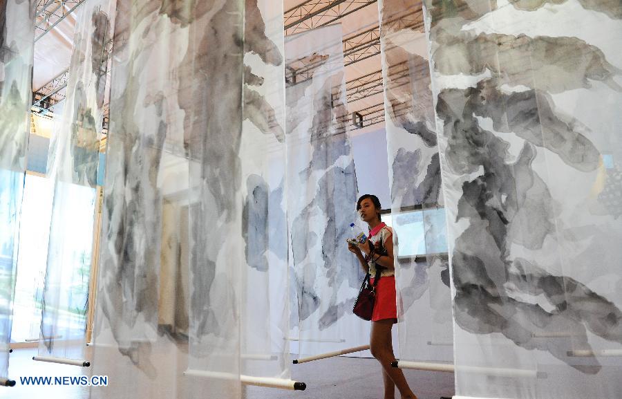 Une visiteuse contemple une œuvre d'art, lors de l'édition 2013 de L'exposition internationale "Science et Art" de Shanghai, en Chine orientale, le 28 août 2013.
