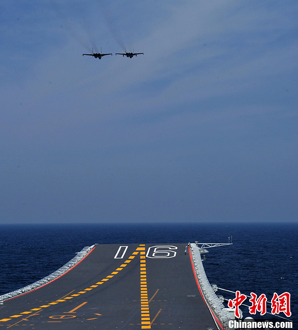 Deux chasseurs J-15 survolent le premier porte-avions chinois, le Liaoning, dans le cadre des récents essais en mer qui ont conduit le porte-avions à la plus longue distance de son port d'attache, la ville de Qingdao, dans la province du Shandong, et qui furent aussi les plus longs jusqu'à ce jour en termes de durée. Plus de 100 tests de décollage et d'appontage ont été réalisés sur le navire avant son retour à Qingdao samedi.