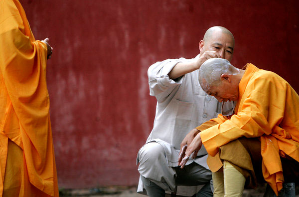 Des moines de Shaolin se font raser la tête, avant un rituel au temple Shaolin de Dengfeng, la province du Henan, le 24 mai 2007.