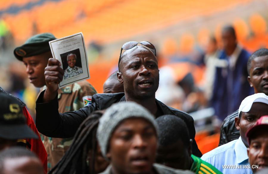 Les Sud-Africains participent à la cérémonie d'adieu de Mandela sous la pluie (3)