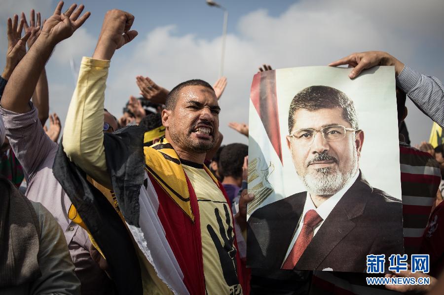 Le 4 novembre 2013, à l'extérieur de l'académie de Tagamoa el Khamaes à la périphérie du Caire où a lieu le procès de Mohammed Morsi, des partisans se rassemblent pour exprimer leur soutien au président déchu. (Photo : Xinhua/Pan Chaoyue)