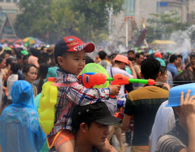 Un jeune garçon utilise un pistolet à eau pour envoyer des jets d'eau pendant le Festival du Songkran, dans la ville de Jinghong, dans le Xishuangbanna, le 15 avril.