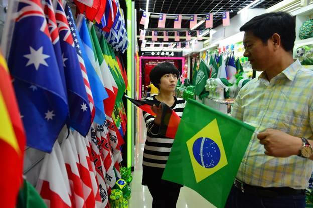 Un homme d'affaires choisit des drapeaux pour la prochaine Coupe du Monde au Brésil, à la Cité du Commerce International d'Yiwu. 